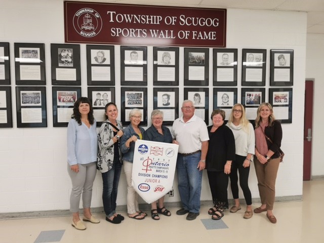 1995 Ringette All-Ontario Champs team holding banner in front of Sports Wall of Fame