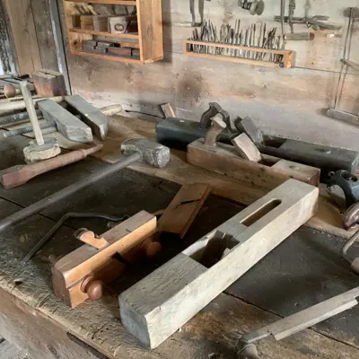 pieces of wood and tools laying on a bench