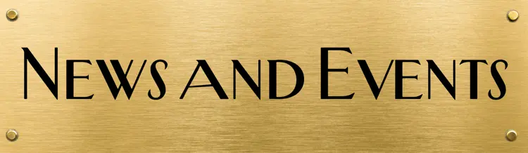 Gold plaque with centred black text reading "News and Events"