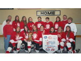IGA Ringette team in red jerseys standing on ice in front of home bench