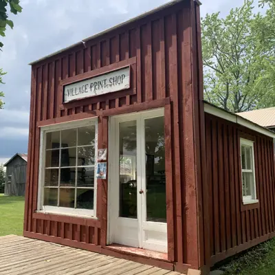 Red print shop with large windows and white door