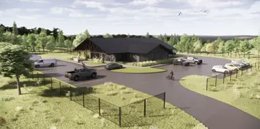 aerial view of site with parking lot and building