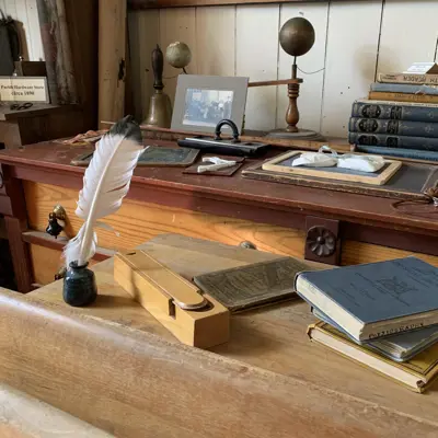 Desk with books and feather on it