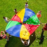 kids standing around a parachute